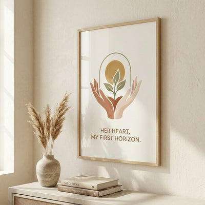 Elegant angled photo of a minimalist poster with a terracotta and gold design and a unique mother's quote, framed in natural wood on a cream wall next to pampas grass and a vase in a modern living room