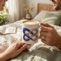 Celestial Quantum Infinity 11oz white ceramic mug in a cozy lifestyle setting, perfect for romantic couples.