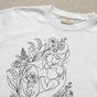 "Emotional Mother's Day 2026 gift idea featuring hand-drawn floral line art on a soft pink boutique tee."