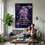 A happy couple sitting on a sofa with the Clearest Glitch poster framed on the wall behind them