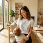 "Modern minimalist one-line art motherhood illustration on a premium white classic fit cotton t-shirt."