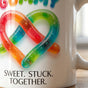 Close up macro view of high gloss ORCA ceramic coating showing vivid colors of a sublimation printed mug.