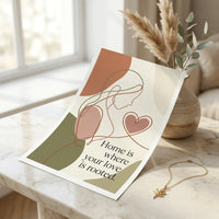 Minimalist Mother's Day poster featuring abstract line art of mother and heart with unique quote: 'Home is where your love is rooted.' Set on cream marble with dried flowers and gold necklace. Warm minimalism style, printed in USA